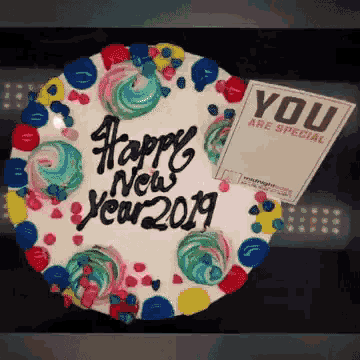 a cake that says happy new year 2019 with a note that says you are special