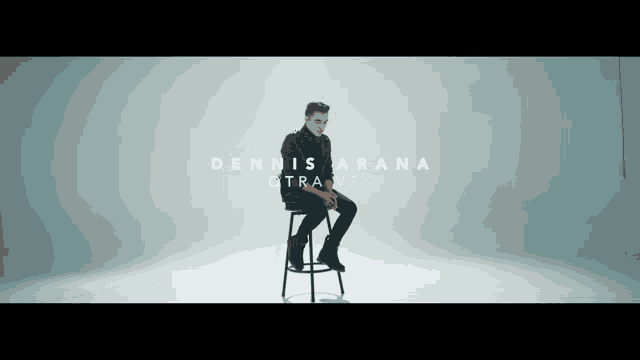 a man sits on a stool with the name dennis arana written on the bottom
