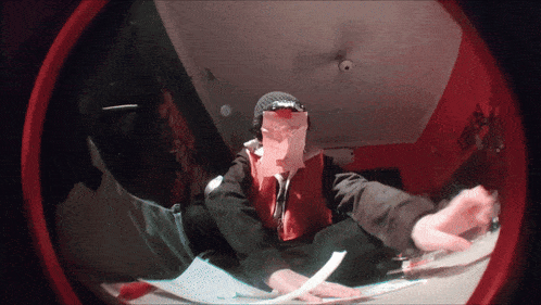 a person wearing a supreme hat and hoodie