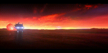 a car is driving down a road at sunset with a red sky in the background .