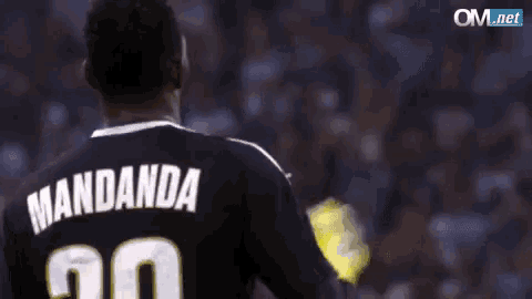 a man wearing a black jersey with the name mandanda on it