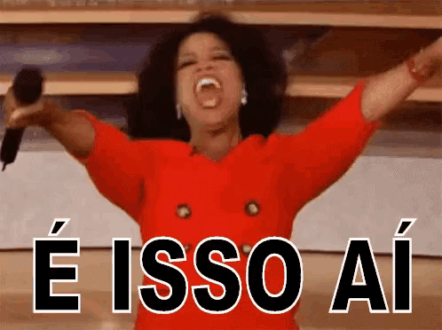 a woman in a red dress is holding a microphone with her arms outstretched and the words e isso ai behind her