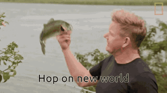 a man holding a fish in his hand with the words hop on new world below him