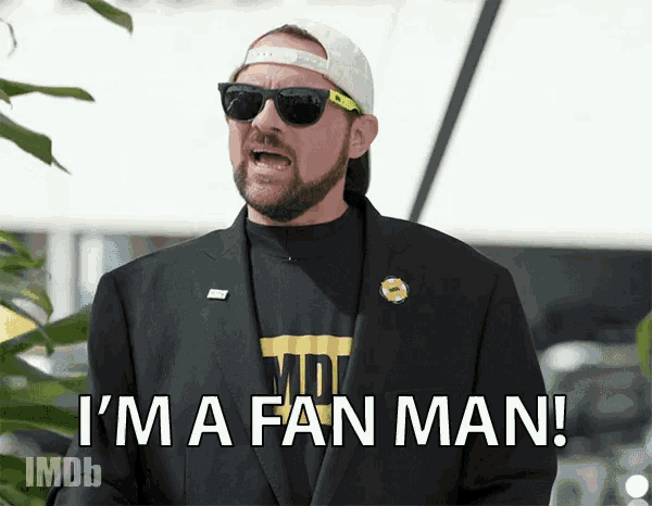 a man wearing sunglasses and a hat is saying i 'm a fan man