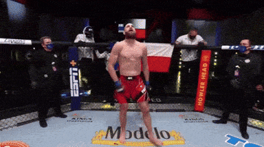 a man stands in a boxing ring that says modelo