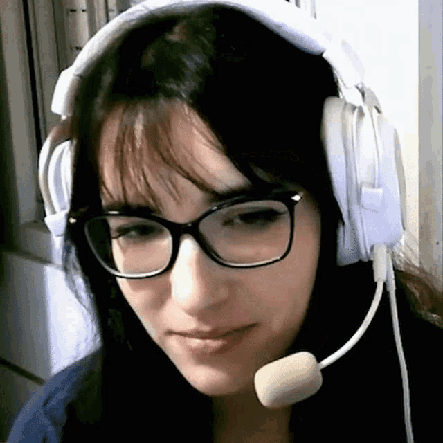 a woman wearing glasses and headphones with a microphone attached to her head