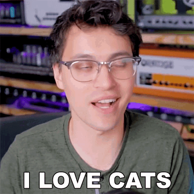 a man wearing glasses says " i love cats "
