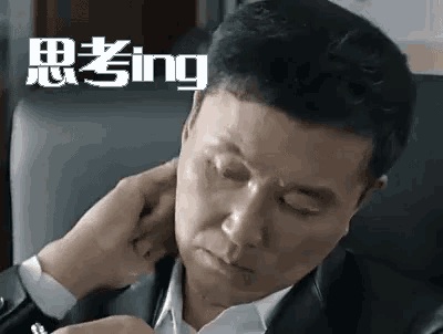 a man in a suit and tie is sitting in a chair with his eyes closed and his hand on his neck .
