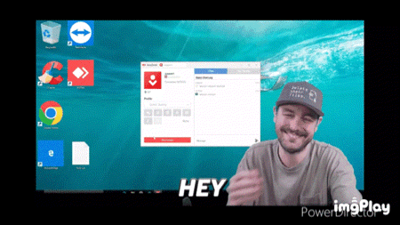 a man wearing a hat is smiling in front of a computer screen that says hey on it