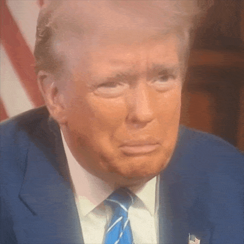 a close up of donald trump 's face with his eyes closed