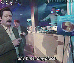 a man in a suit is pointing at a sign that says any time any place