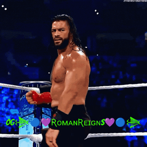 a man in a boxing ring with roman reigns written in green