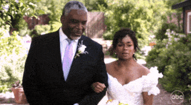 a man in a suit is walking a bride down the aisle with abc written on the bottom right