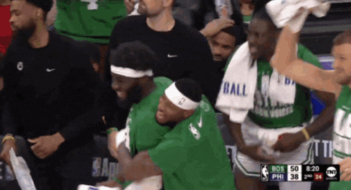 a group of basketball players wearing green and white jerseys with ball on the front