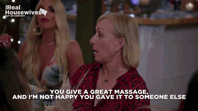 two women are sitting at a table and one of them says you give a great massage and i m not happy you gave it to someone else