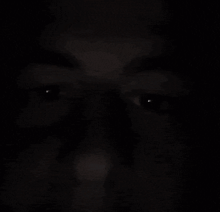 a close up of a person 's face in the dark .