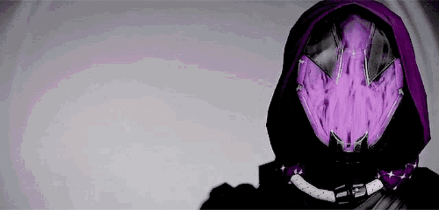 a person wearing a purple helmet with a hood and a purple light coming out of it .