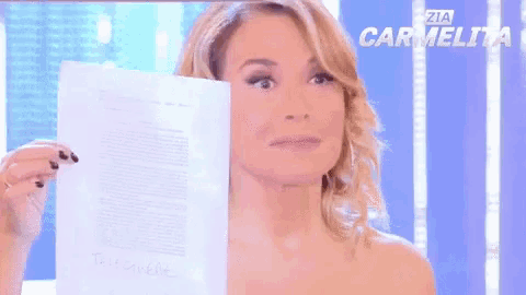 a woman is holding a piece of paper in her hand .