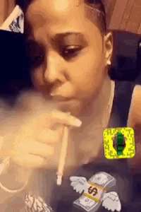 a woman is smoking a cigarette while wearing a shirt with money on it .