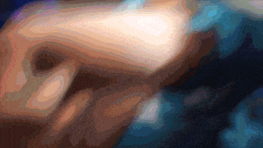 a blurry picture of a person 's face with a blue and orange background