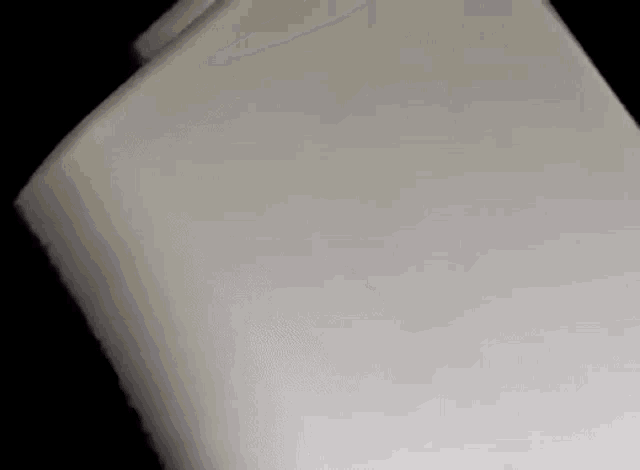a close up of a white block of foam on a black background .