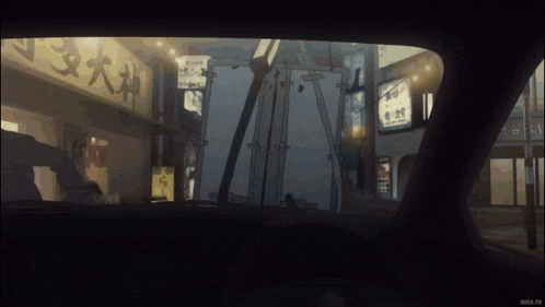 a car is driving down a street at night with a sign that says ' snta.tv ' on it