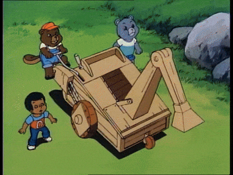 two teddy bears are standing next to a wooden vehicle with the letter d on the front