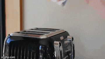 a black toaster is sitting on a counter next to a window