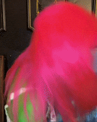 a woman with colorful hair and a skeleton on her head