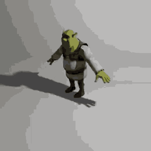shrek from shrek is walking on a white surface with his arms outstretched and his shadow behind him .