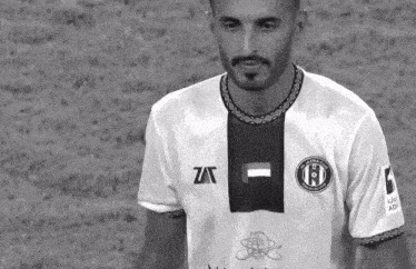 a black and white photo of a man wearing a shirt that says zat