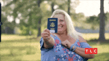 a woman is holding a passport in front of her face and the letters tlc are next to her