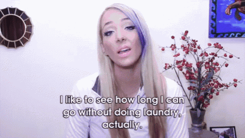 a woman with purple hair says i like to see how long i can go without doing laundry