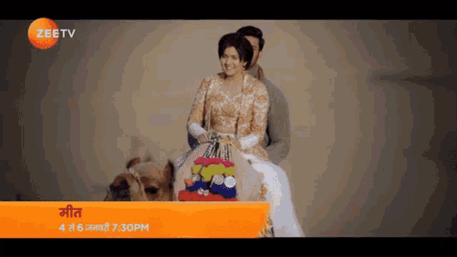 a man and a woman are riding on the back of a camel on a zee tv ad