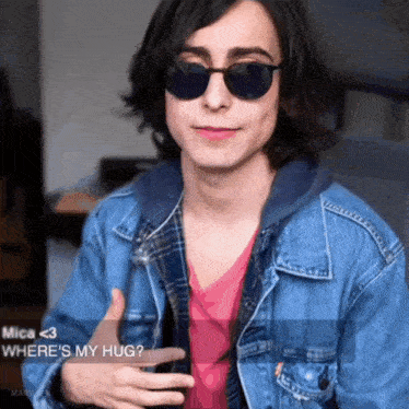 a young man wearing sunglasses and a denim jacket says where 's my hug