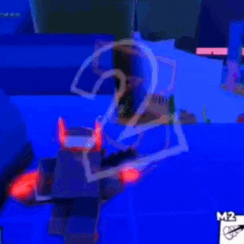a person is playing a video game in a dark room with a blue light behind them .