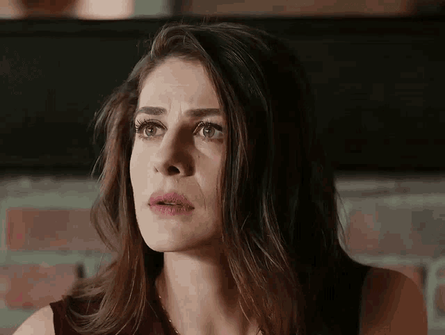 a close up of a woman 's face with her mouth open
