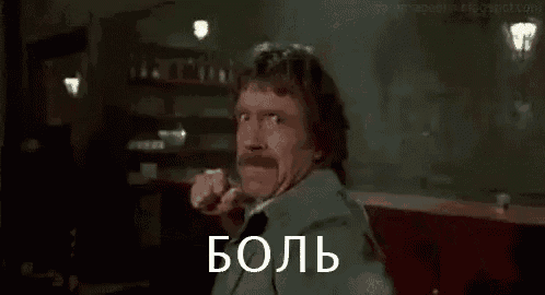 a man with a mustache is making a funny face and holding his fist up in the air .