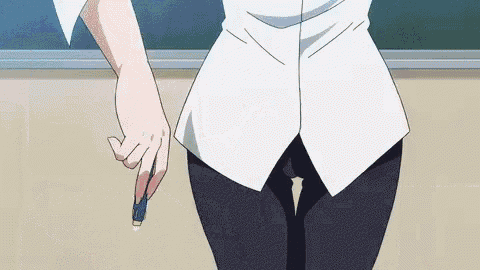 a person is holding a pencil in their hand in front of a blackboard .