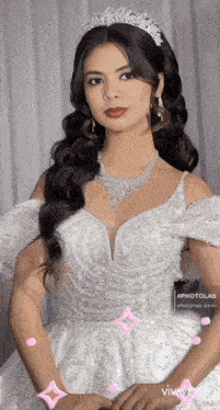a woman wearing a white dress and a tiara