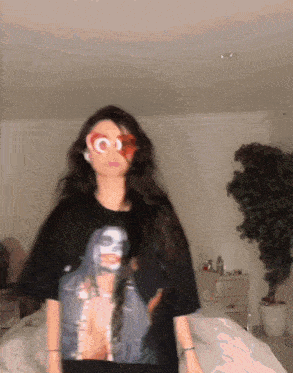a woman wearing a black t-shirt with a picture of a man on it