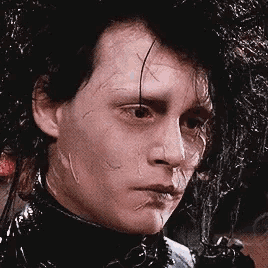 a close up of a man 's face with a spider on his face .