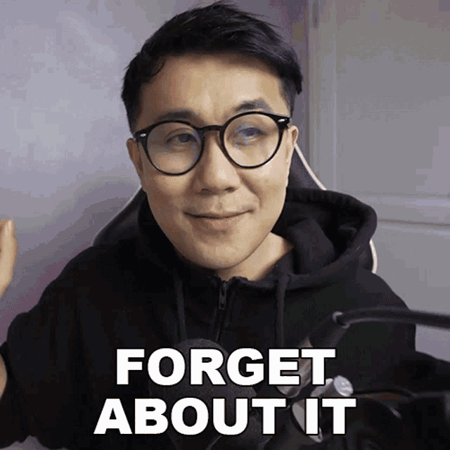 a man with glasses and a black hoodie says forget about it