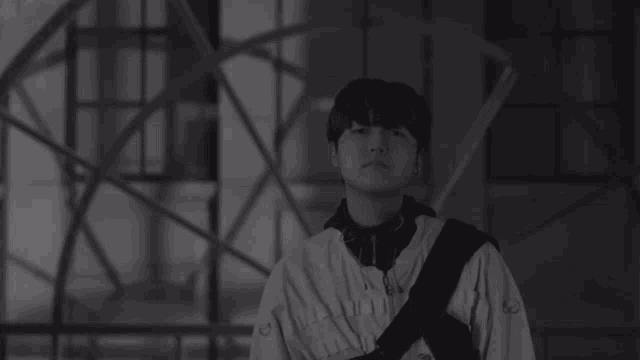 a black and white photo of a young man wearing a sweatshirt that says ' n ' on it