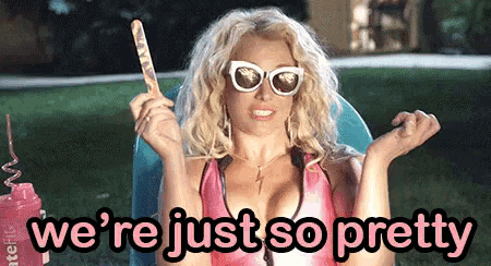 a blonde woman holding a stick with the words " we 're just so pretty " above her