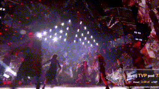 a group of people are dancing on a stage with a tvp pod 7 sign in the background