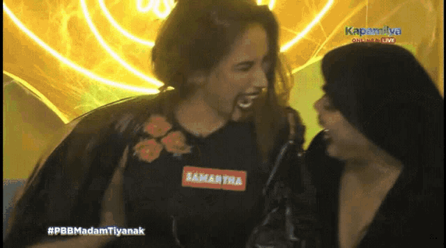 a woman with the name samantha on her shirt is laughing with another woman