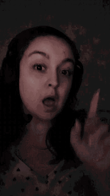 a woman is wearing headphones and pointing up with the word boop above her