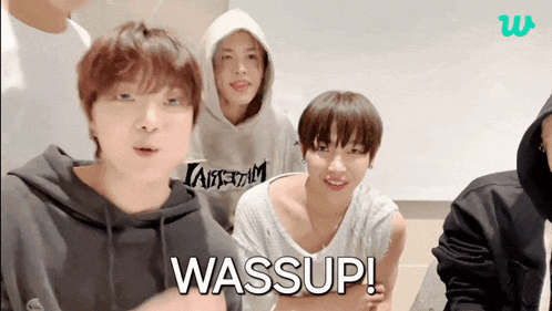 a group of young men are looking at the camera and one of them is wearing a hoodie that says taipei on it