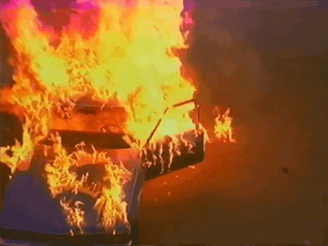a piano is on fire in a dark room .